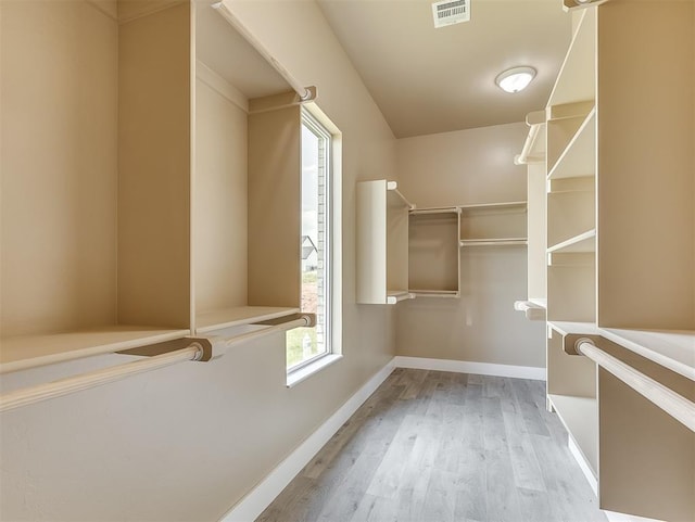 spacious closet featuring light hardwood / wood-style floors