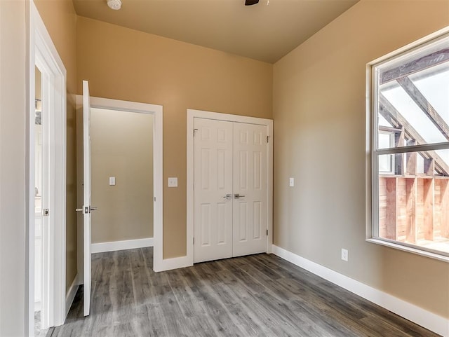 unfurnished bedroom with hardwood / wood-style floors and a closet