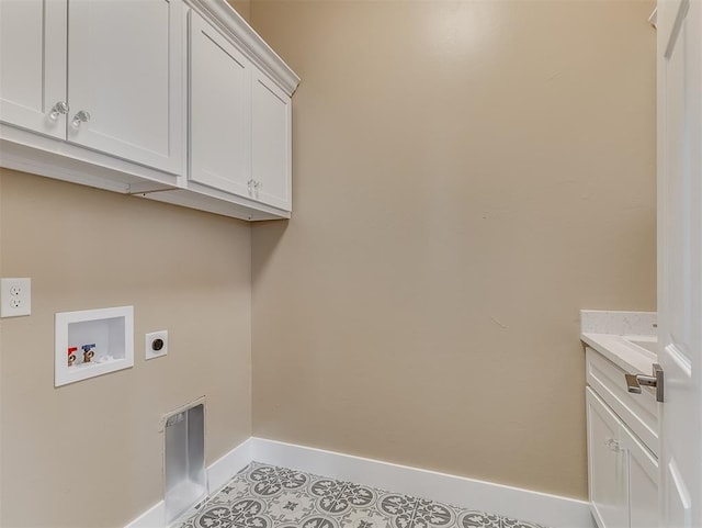 laundry area with electric dryer hookup, washer hookup, light tile patterned floors, and cabinets