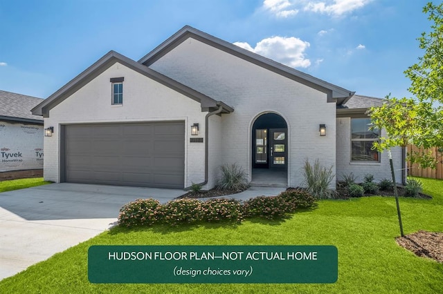 view of front of home with a garage and a front lawn