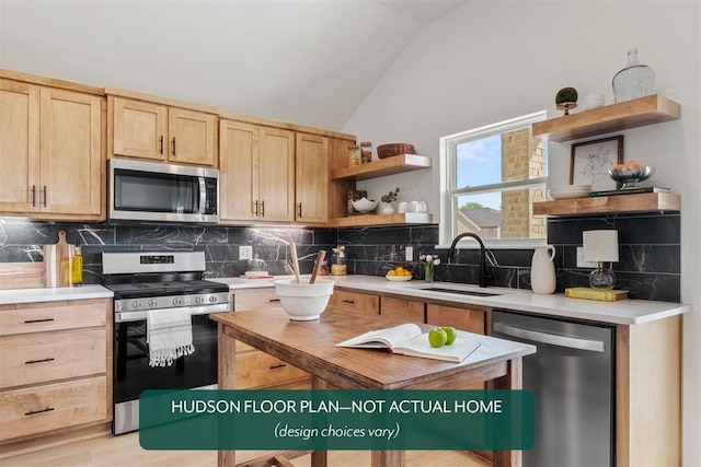 kitchen featuring lofted ceiling, sink, decorative backsplash, and stainless steel appliances