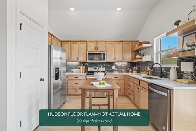 kitchen with lofted ceiling, sink, stainless steel appliances, and light brown cabinetry