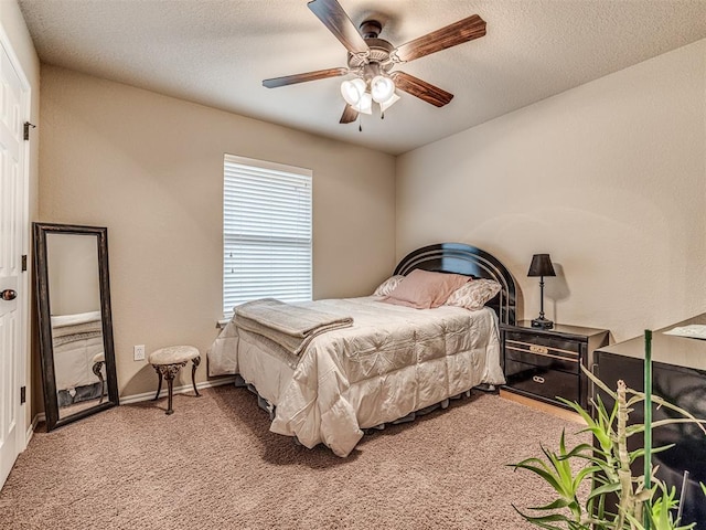 carpeted bedroom with a textured ceiling and ceiling fan