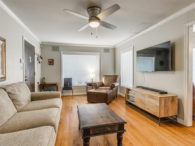 living room with ornamental molding, hardwood / wood-style floors, and ceiling fan