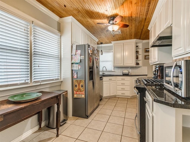 kitchen featuring hanging light fixtures, light tile patterned flooring, appliances with stainless steel finishes, and white cabinets