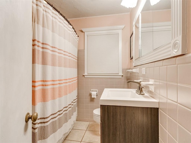 bathroom with curtained shower, tile walls, tile patterned flooring, vanity, and toilet