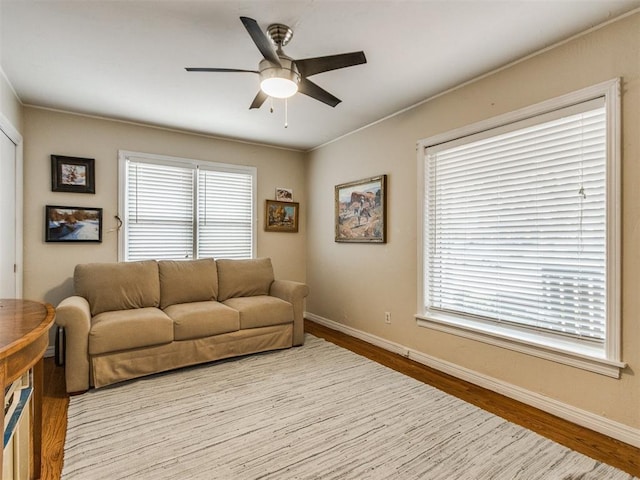 living room featuring light hardwood / wood-style flooring and ceiling fan