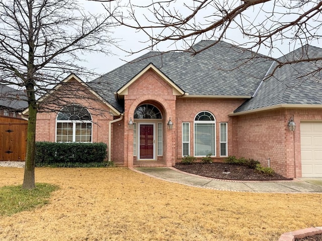 view of front of home with a garage and a front lawn