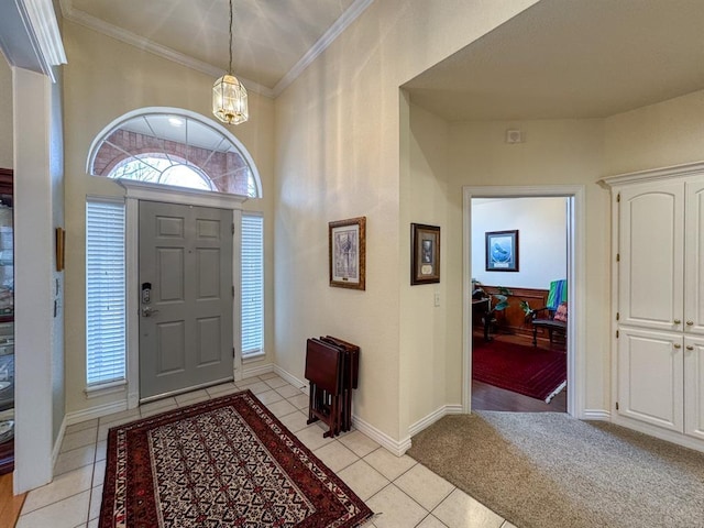 entryway featuring crown molding, a chandelier, and light tile patterned flooring