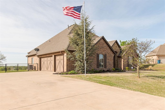 view of front of property with a garage and a front yard