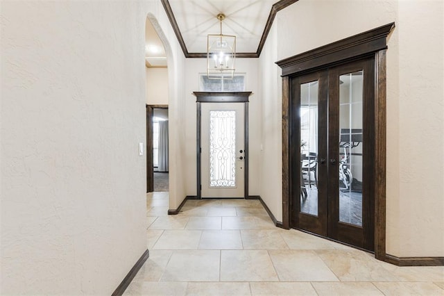 entrance foyer with ornamental molding and french doors