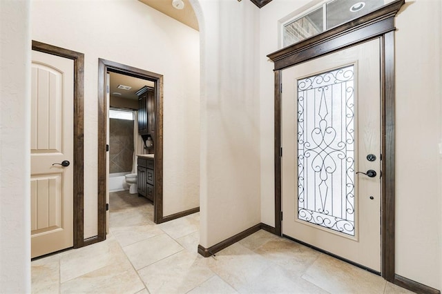 foyer entrance with light tile patterned floors