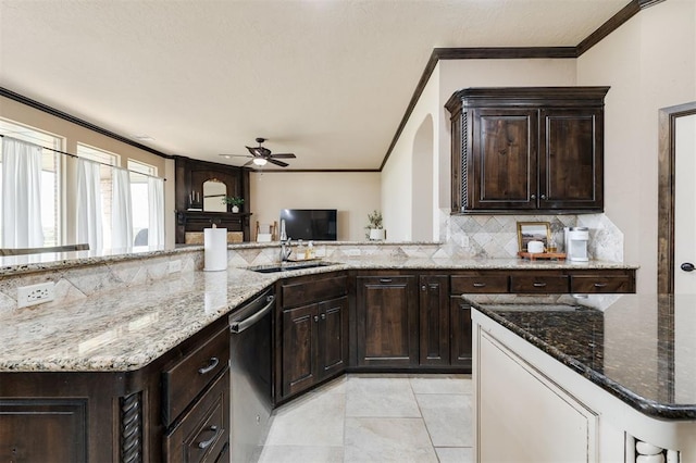 kitchen featuring crown molding, decorative backsplash, dishwasher, and light stone countertops