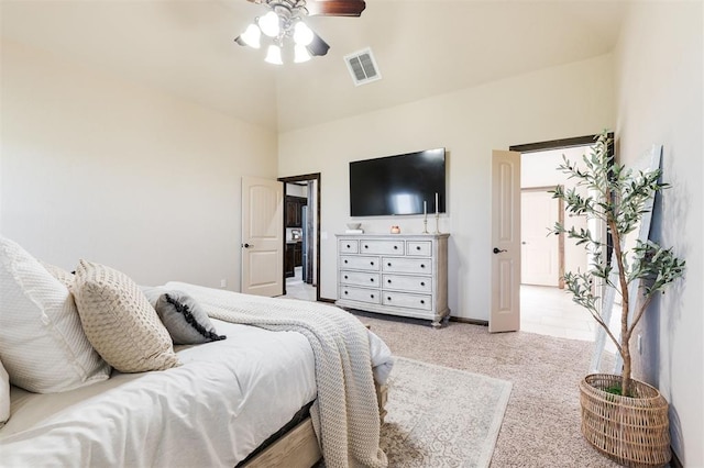 bedroom featuring lofted ceiling, light colored carpet, and ceiling fan