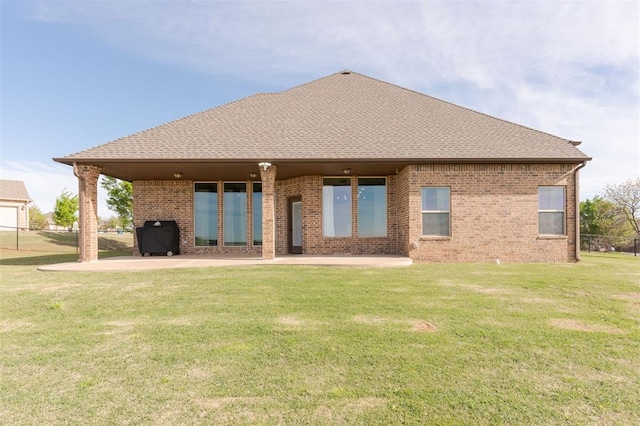 back of house with a patio area and a lawn