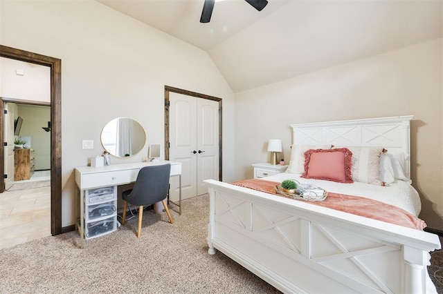 carpeted bedroom with ceiling fan, lofted ceiling, and a closet