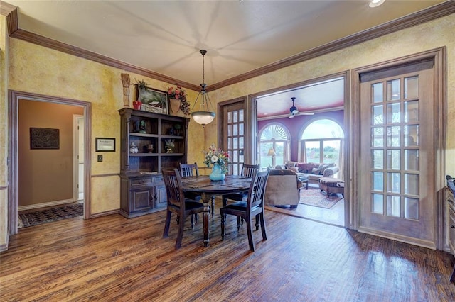 dining room featuring crown molding and dark wood-type flooring