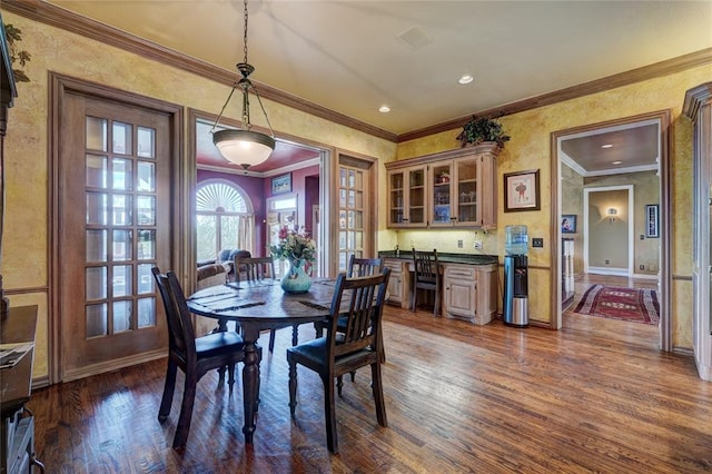 dining room with ornamental molding and dark hardwood / wood-style floors