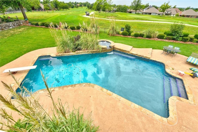 view of swimming pool with a patio, a diving board, and a yard