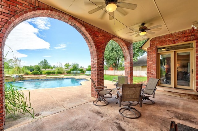 view of pool with pool water feature, ceiling fan, and a patio area