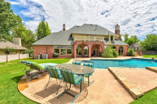 view of pool with a yard, central AC, and a patio area