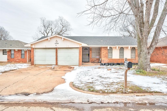 ranch-style home with an attached garage, a shingled roof, concrete driveway, and brick siding