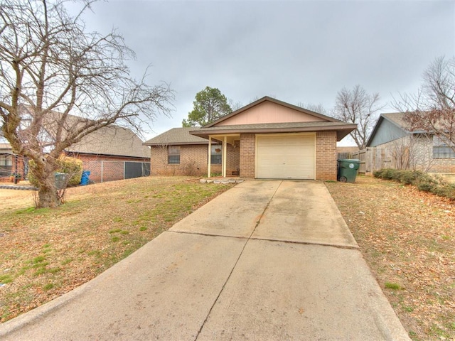 ranch-style house featuring a garage and a front lawn