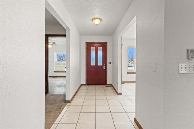 tiled entryway with a textured ceiling