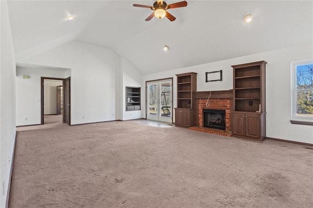 unfurnished living room featuring vaulted ceiling, light carpet, ceiling fan, and a fireplace