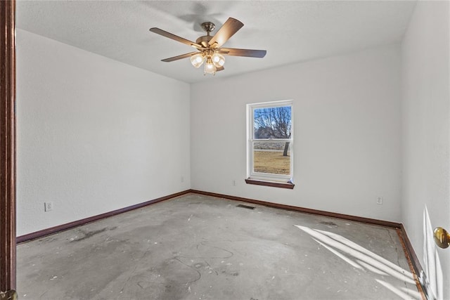 empty room featuring a textured ceiling, concrete flooring, and ceiling fan