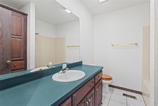 bathroom with vanity, tile patterned floors, and toilet