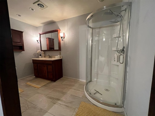 full bathroom with a stall shower, vanity, and baseboards