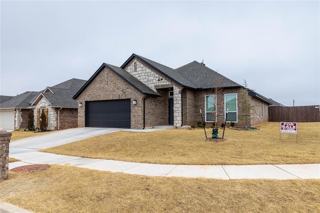 view of front of home with a garage and a front lawn