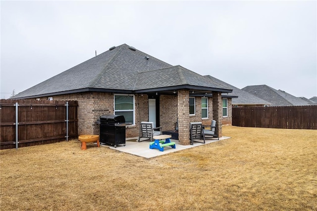 back of house featuring a yard and a patio area