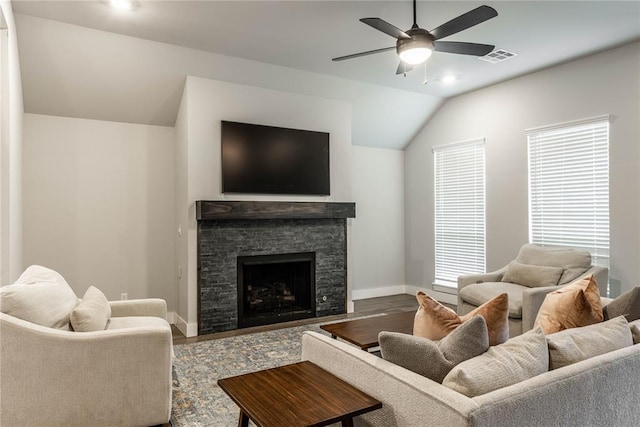 living room with lofted ceiling, hardwood / wood-style flooring, a fireplace, and ceiling fan