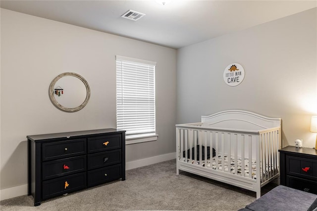 bedroom featuring light carpet and a crib