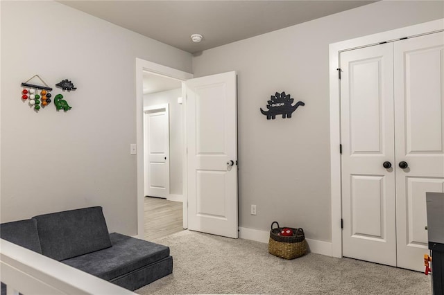 sitting room featuring light carpet