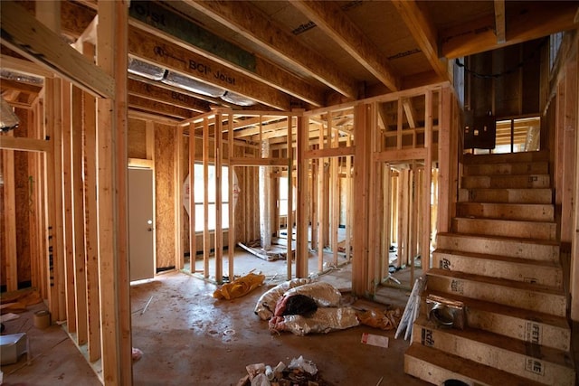 miscellaneous room featuring plenty of natural light and stairway