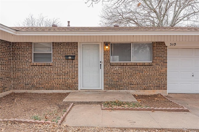 view of exterior entry with a garage