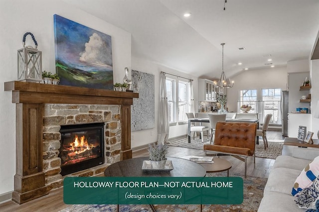 living room featuring an inviting chandelier, lofted ceiling, a stone fireplace, and hardwood / wood-style floors