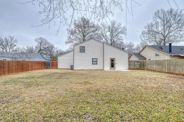 back of house with cooling unit, a lawn, and a patio area