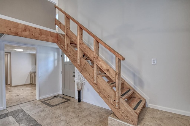 staircase with a towering ceiling