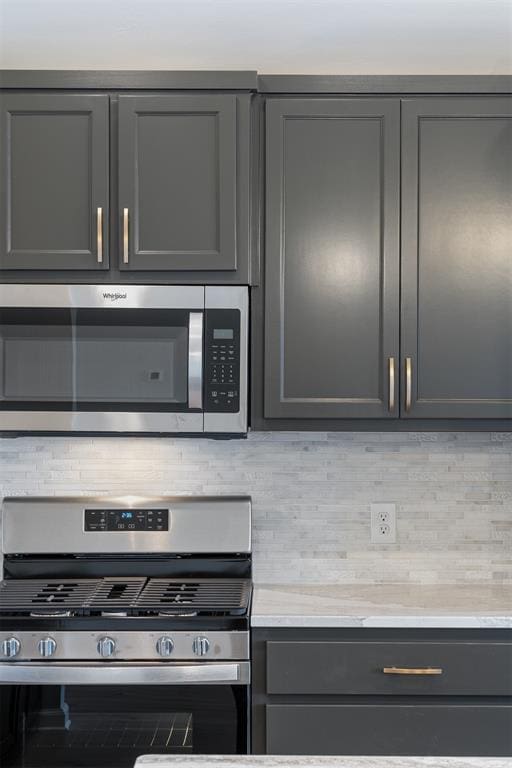 3400 Piney River Dr, Yukon, OK 73099 - kitchen featuring stainless steel appliances, light countertops, backsplash, and gray cabinetry