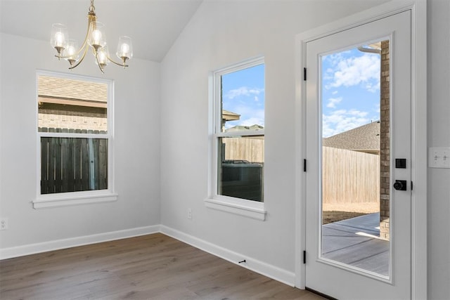 3400 Piney River Dr, Yukon, OK 73099 - entryway with an inviting chandelier, vaulted ceiling, baseboards, and wood finished floors