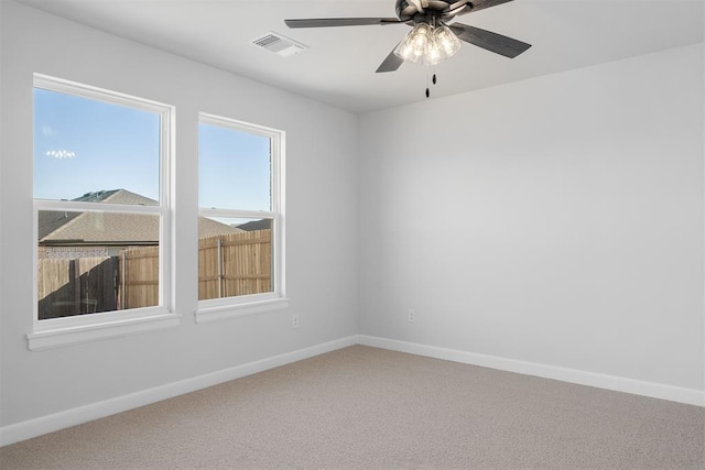 3400 Piney River Dr, Yukon, OK 73099 - carpeted spare room featuring baseboards, visible vents, and a ceiling fan
