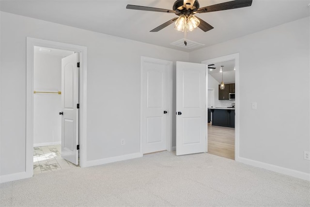 3400 Piney River Dr, Yukon, OK 73099 - unfurnished bedroom with baseboards, ceiling fan, ensuite bath, and light colored carpet