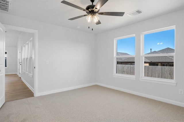 3400 Piney River Dr, Yukon, OK 73099 - spare room with baseboards, visible vents, ceiling fan, and carpet flooring