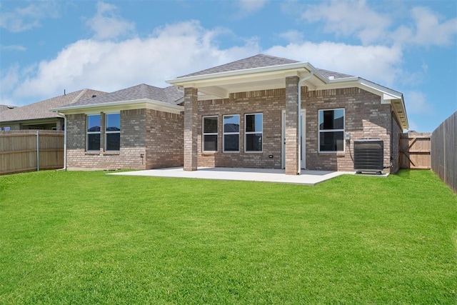 3400 Piney River Dr, Yukon, OK 73099 - rear view of house with brick siding, a patio area, a fenced backyard, and roof with shingles