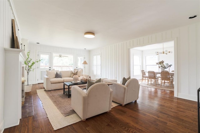 living room featuring dark hardwood / wood-style floors and an inviting chandelier