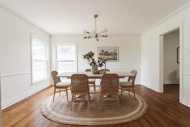 dining area with an inviting chandelier, crown molding, and hardwood / wood-style floors